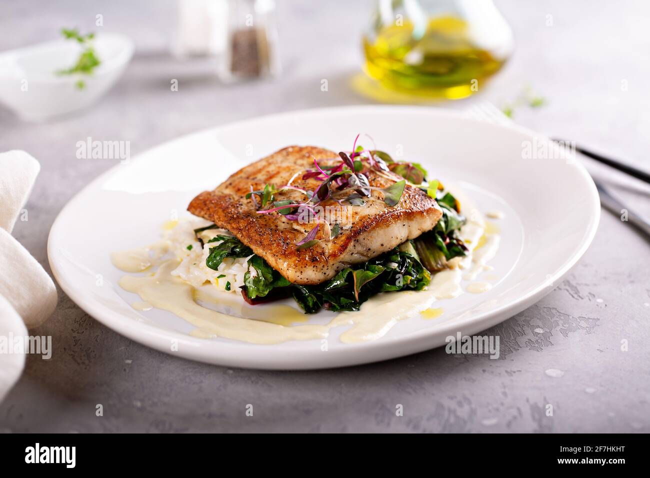 Sauteed fish with leafy greens and rice Stock Photo