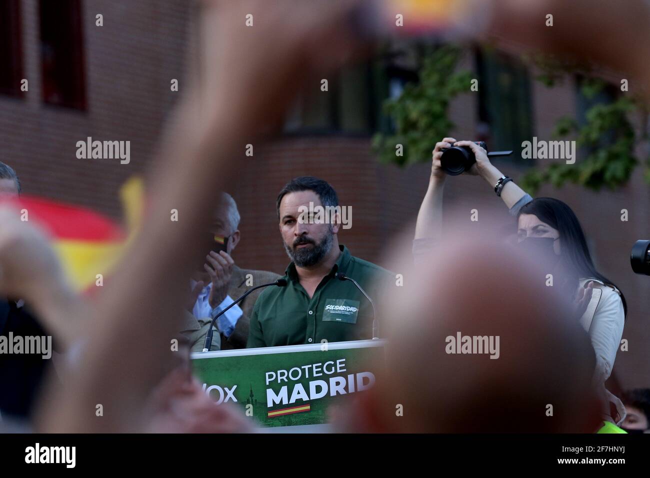 Madrid, Spain; 07.04.2021.- Santiago Abascal leader of VoxVox carries out its first act of electoral pre-campaign in Madrid in the working-class neighborhood of Vallecas. The National Police clash against residents of the Madrid neighborhood, who were protesting the pre-campaign act of the far-right party. The party's leader, Santiago Abascal, interrupted his rally and confronts several participants in the protests. Vox had gathered three hundred attendees in the popularly called 'Red Square' of Vallecas, separated by a narrow police cordon, the residents of the neighborhood chanted shouts of Stock Photo