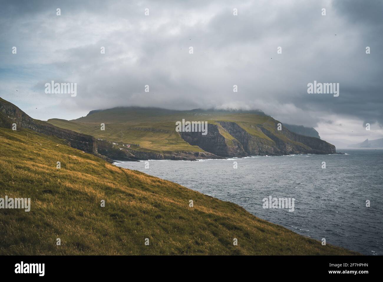 Beautiful Mykines Island with green grass landscapes and Atlantic Ocean. Mykines island, Faroe Islands, Europe. Stock Photo