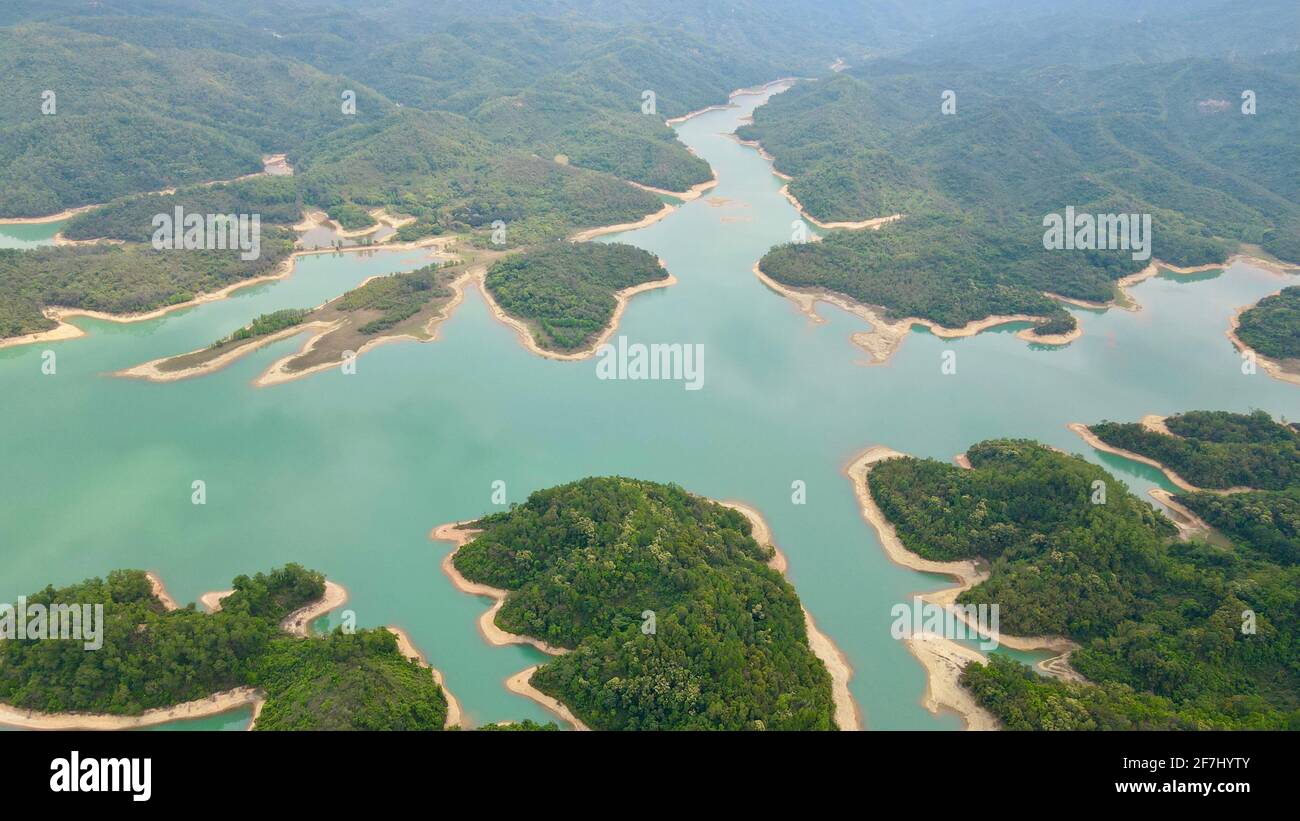 ShiTouShan, aka the Lion Head Mountain in Zhongshan, Guangdong, China, nearby Yangtze River Reservoir with lots of green trees. Stock Photo