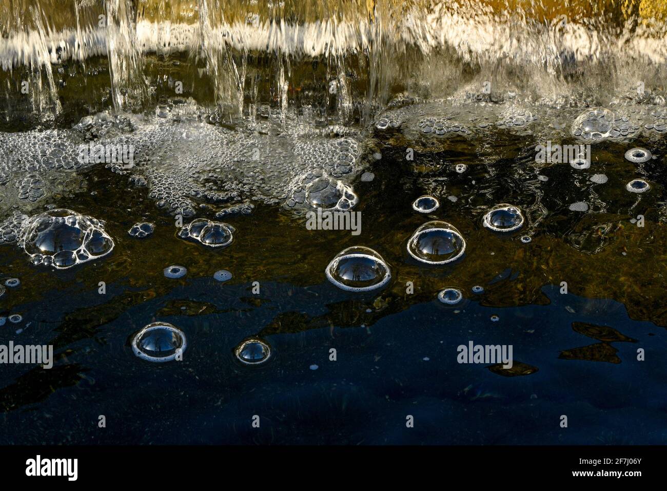 Bubble domes on water created by aeration from mini waterfall Stock Photo