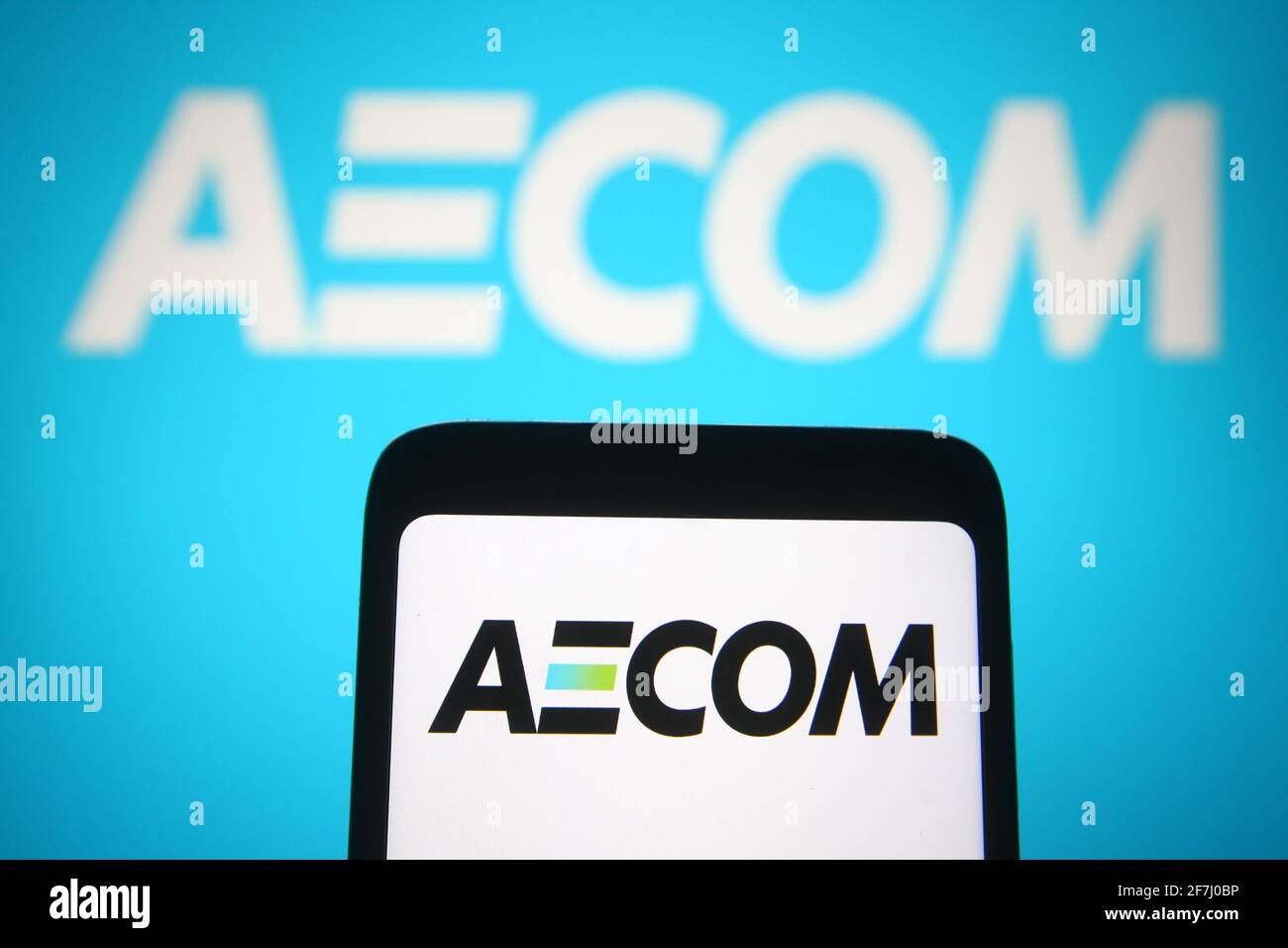 Ukraine. 7th Apr, 2021. In this photo illustration the AECOM logo of an US engineering company is seen on a smartphone and a pc screen. Credit: Pavlo Gonchar/SOPA Images/ZUMA Wire/Alamy Live News Stock Photo