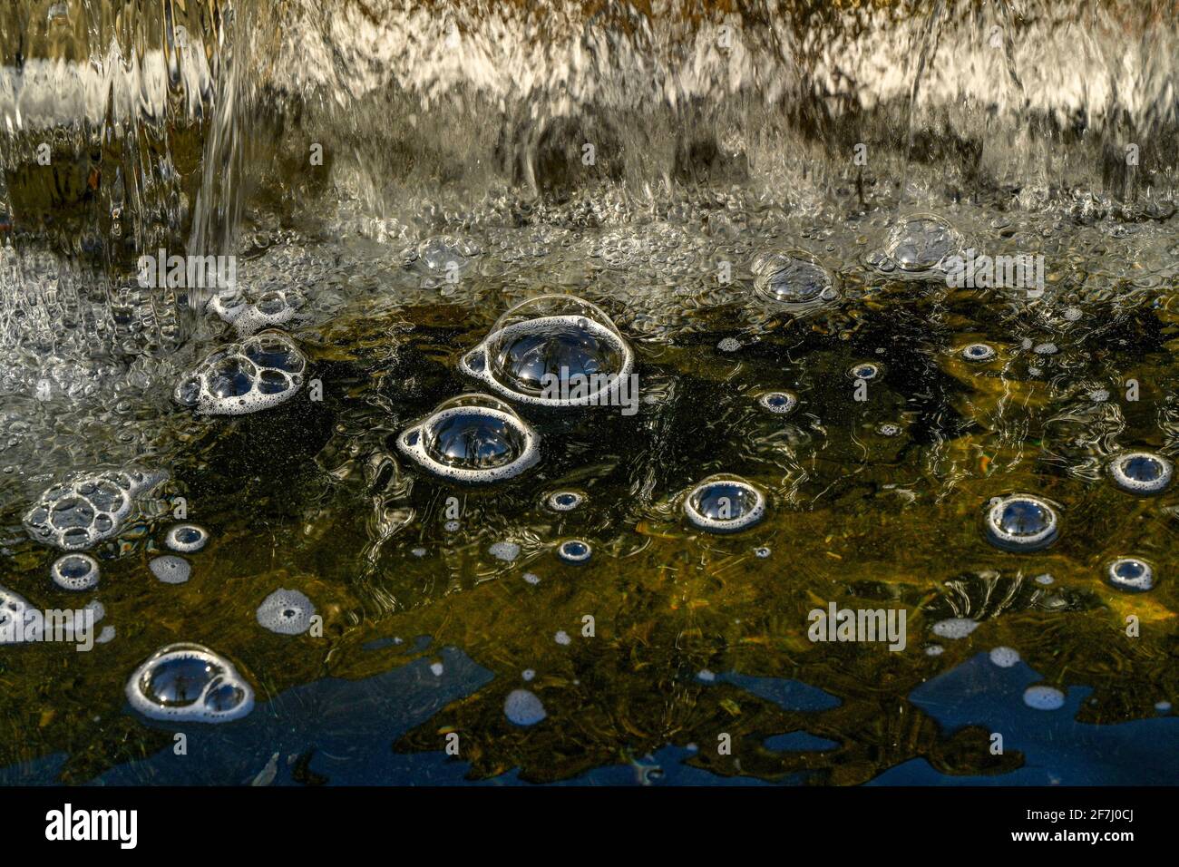 Bubble domes on water created by aeration from mini waterfall Stock Photo