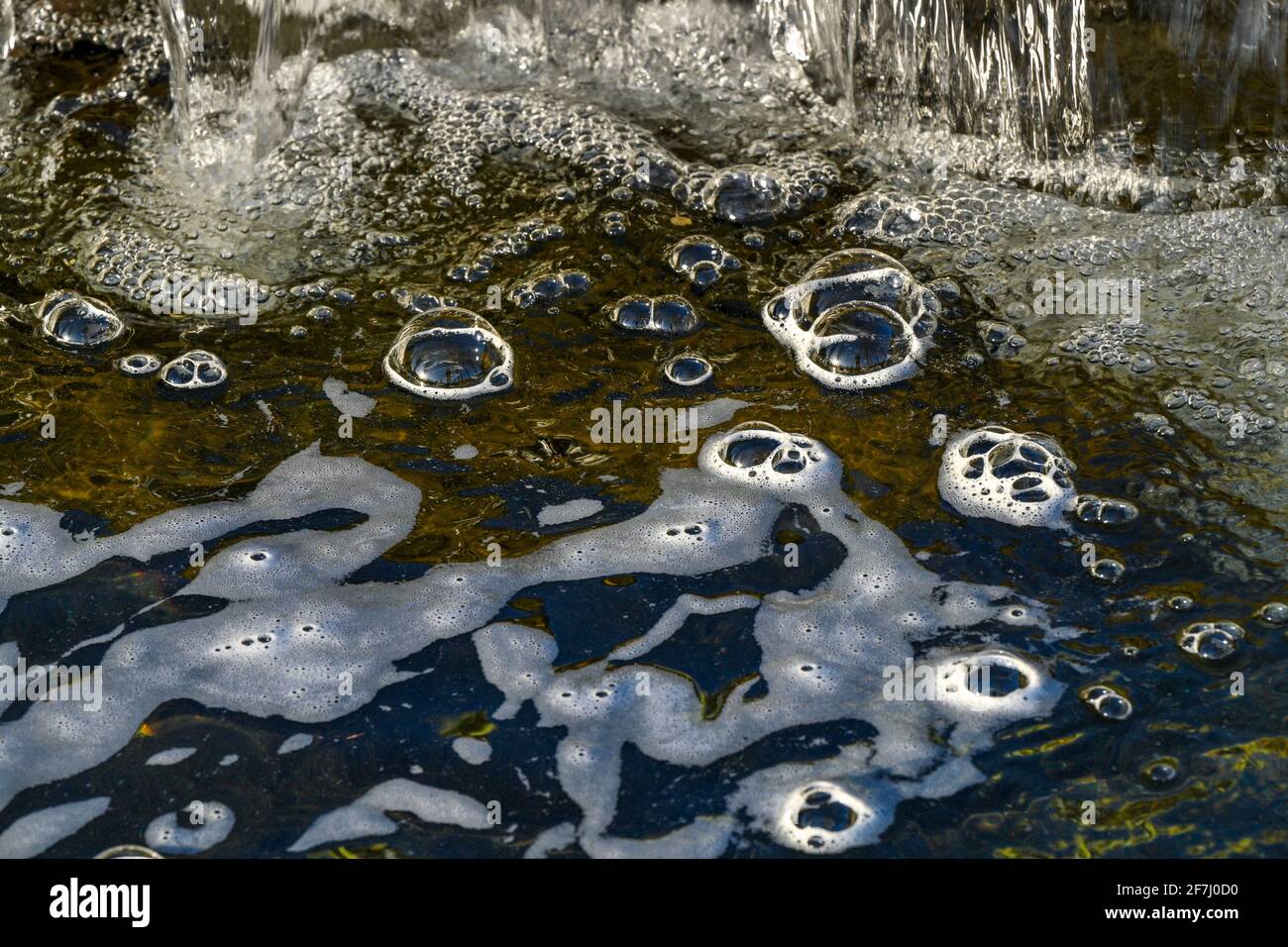Bubble domes on water created by aeration from mini waterfall Stock Photo