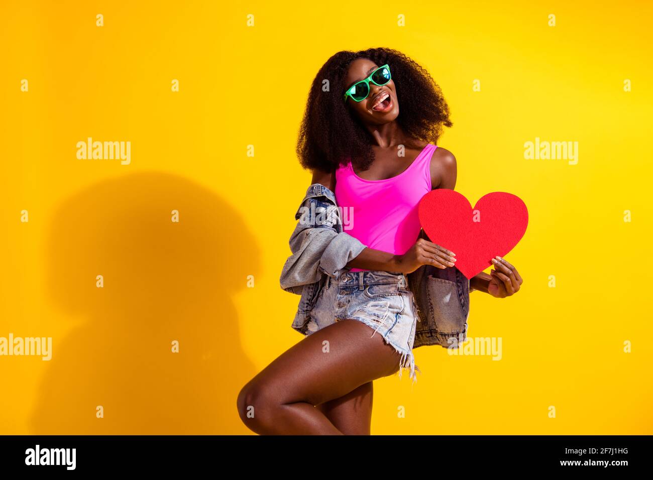 Photo of lovely cute young dark skin woman hold red paper heart ...