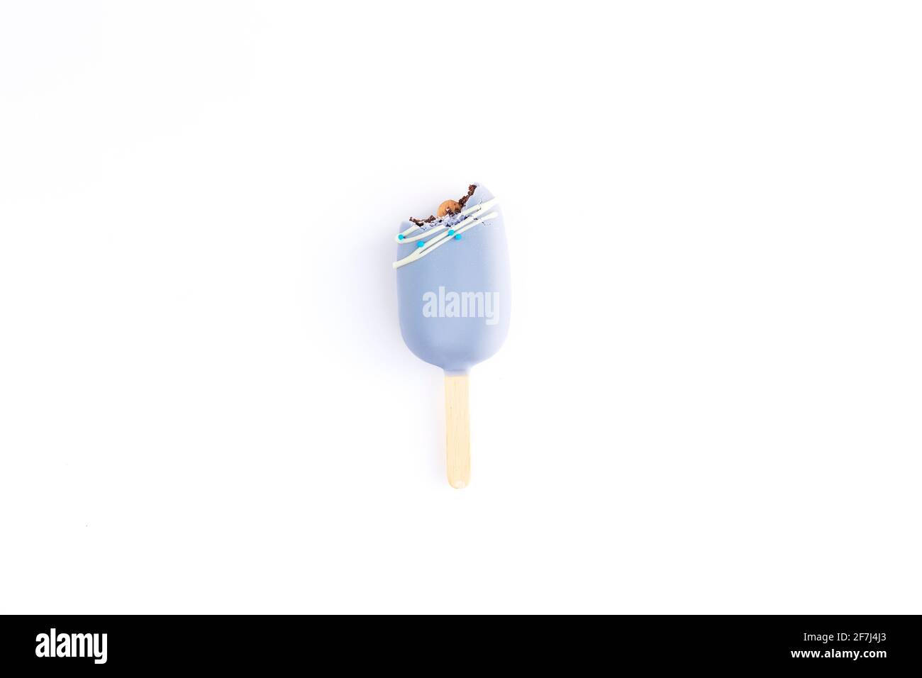Isolated bitten blue cookie ice cream on a stick on white background. Flat lay with ice cream. Stock Photo