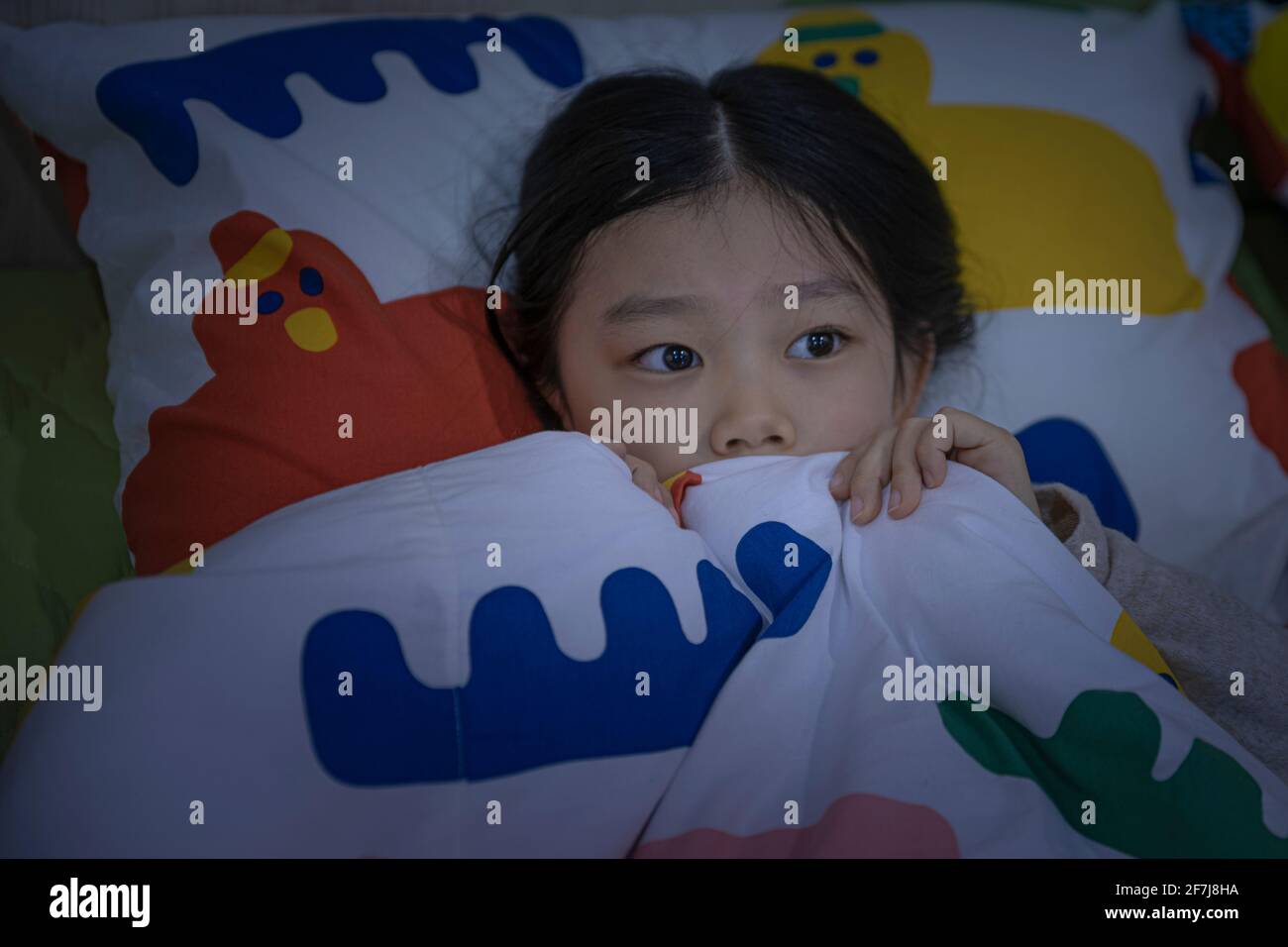 Asian girl scared at night Stock Photo