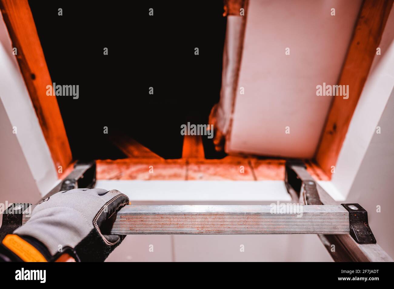 Climbing a ladder into an open attic Stock Photo Alamy