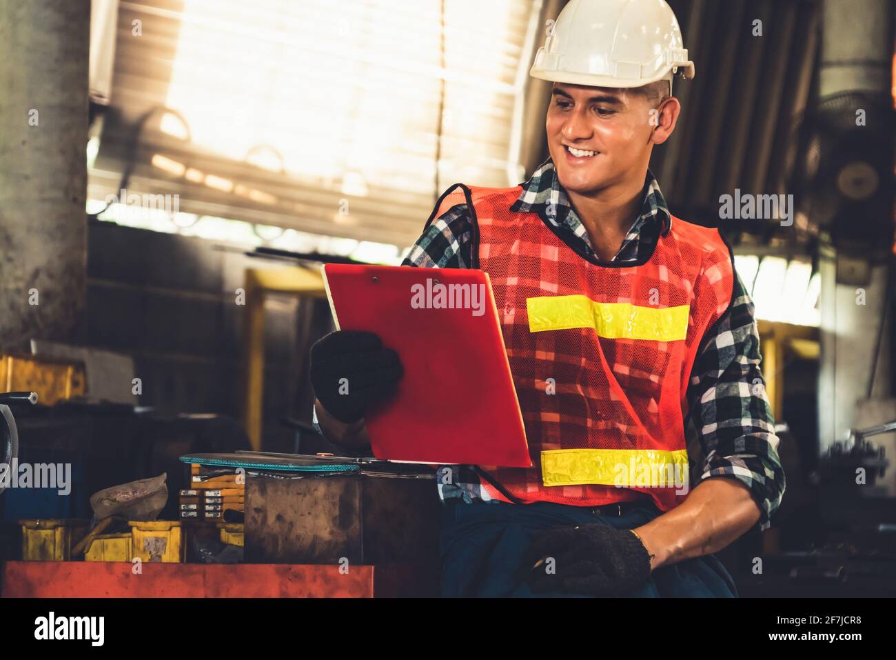 Manufacturing worker working with clipboard to do job procedure