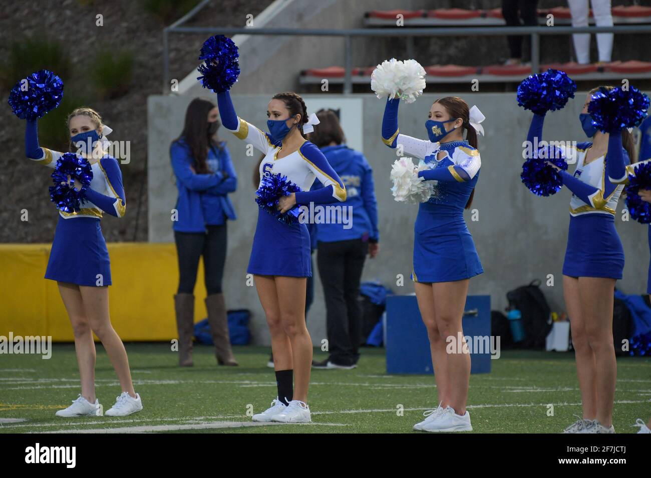 Santa Margarita cheerleaders perform with facial coverings before a high school football game, Saturday, Mar 20, 2021 in Santa Ana, Calif. St. John Bo Stock Photo
