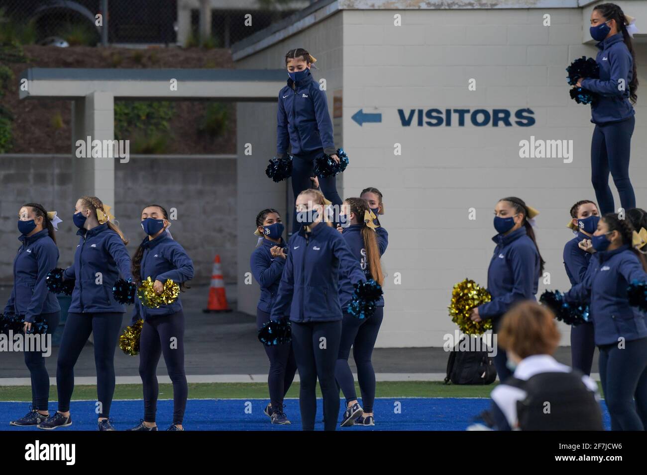 St. John Bosco cheerleaders perform with facial coverings before a high school football game, Saturday, Mar 20, 2021 in Santa Ana, Calif. St. John Bos Stock Photo