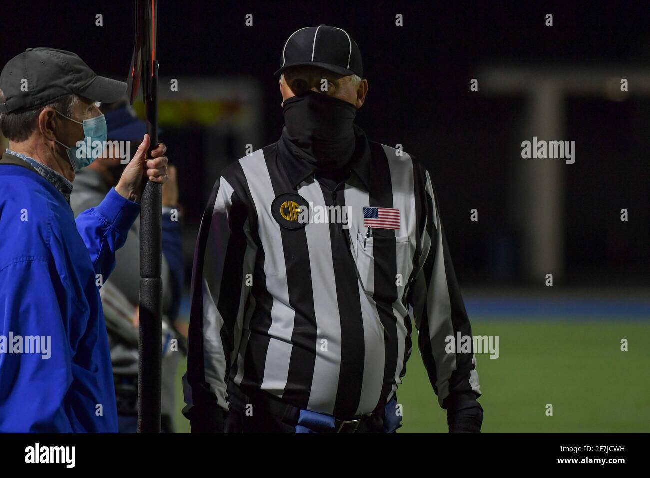 A high school football referee wears a facial covering during a high school football game, Saturday, Mar 20, 2021 in Santa Ana, Calif. St. John Bosco Stock Photo