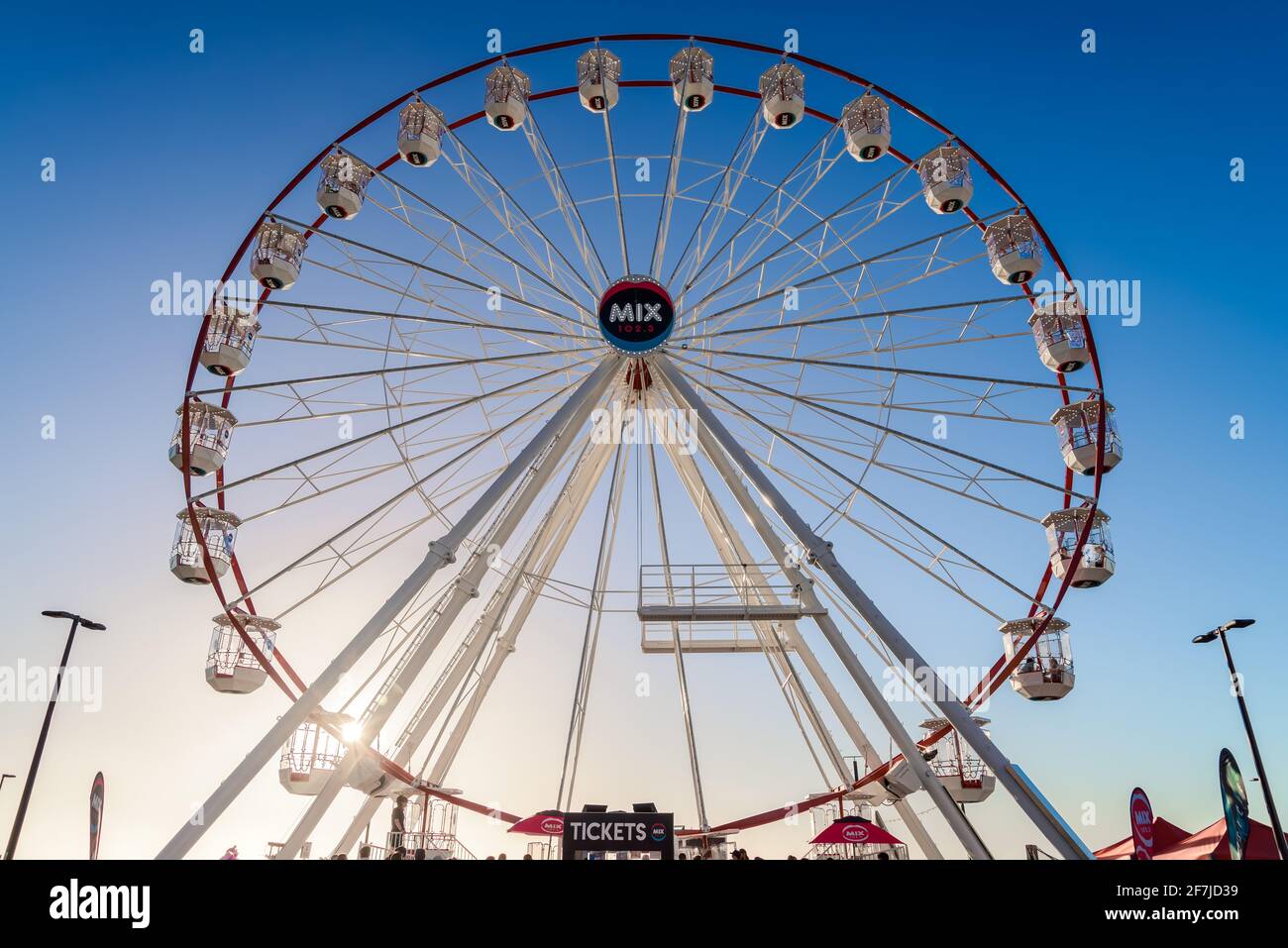 Adelaide, South Australia - January 12, 2019: Glenelg Mix102.3 Giant Ferris Wheel viewed from the Moseley Square on a bright summer day Stock Photo