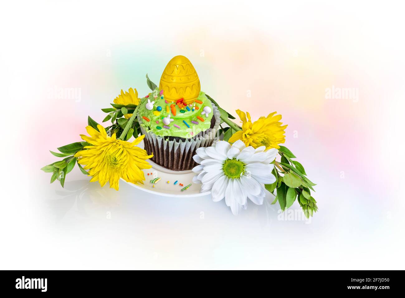 Spring Easter Cupcake and flowers on a white background. Stock Photo