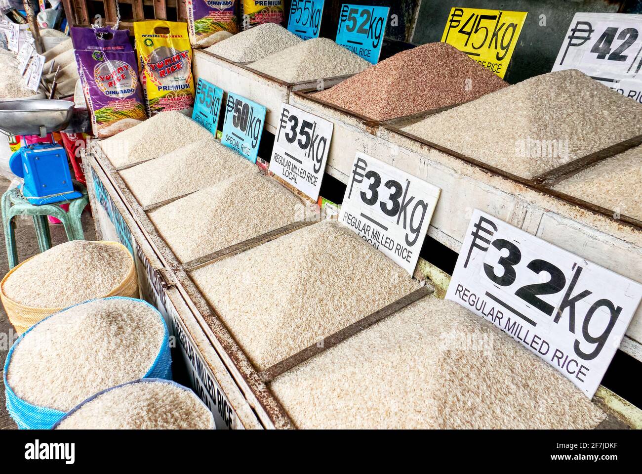 Array of different kind of rice for sale, neatly presented and with price signs attached at a central market in the Philippines, Asia Stock Photo