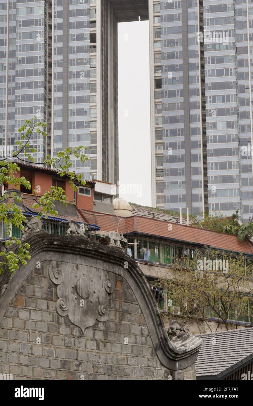 Old house with tile roof in Tai Koo Li with new and tall building nearby, a mixed morden city of Chengdu. Stock Photo