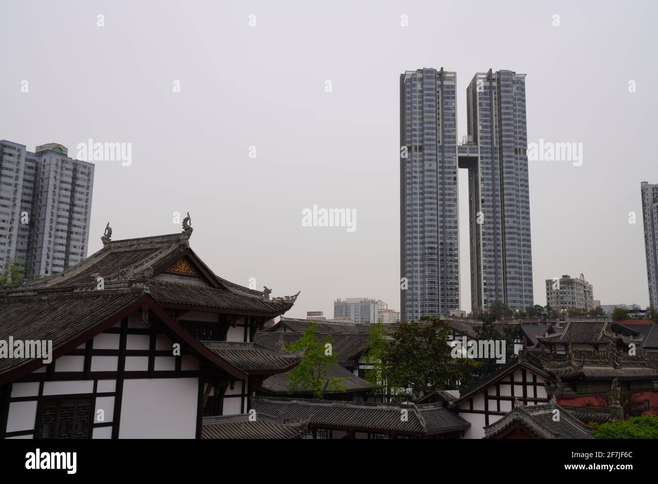 Old house with tile roof in Tai Koo Li with new and tall building nearby, a mixed morden city of Chengdu. Stock Photo
