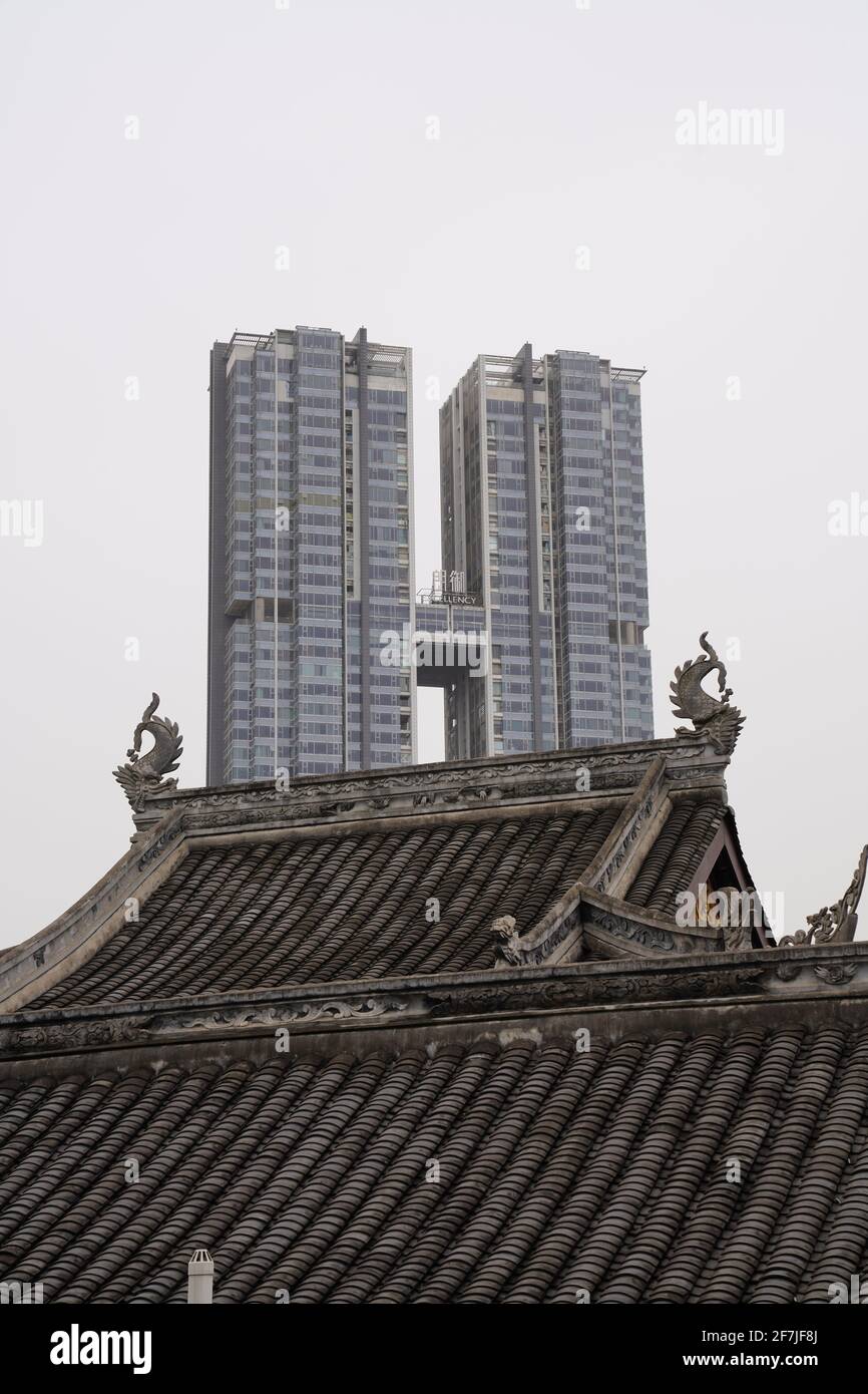 Old house with tile roof in Tai Koo Li with new and tall twin buildings nearby, a mixed morden city of Chengdu. Stock Photo