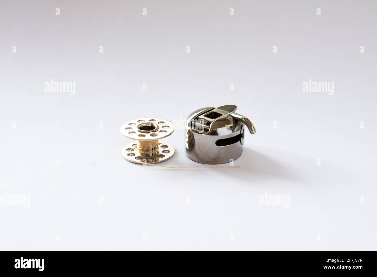 sewing machine bobbin and bobbin case. white background Stock Photo Alamy