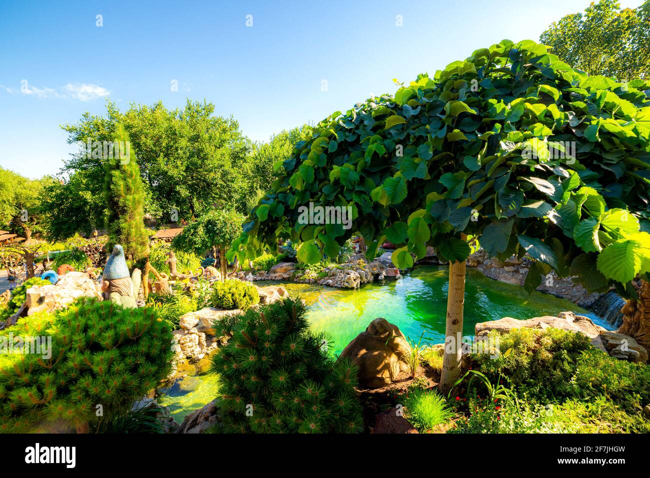 Landscape design. Artificial waterfall in a garden. Stock Photo