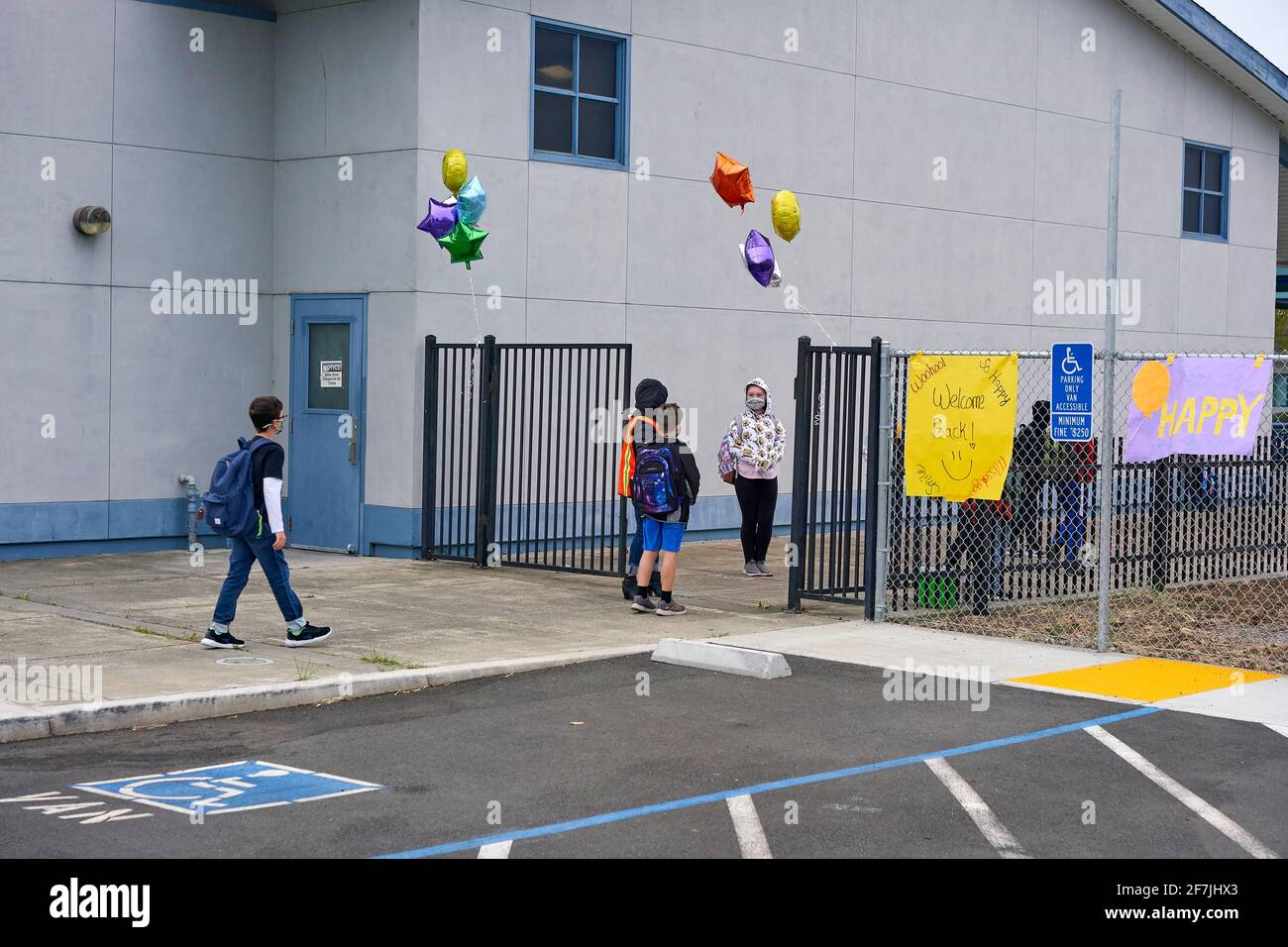 Young students physically distancing and wearing masks return to school as in-person classroom teaching reopens in Sonoma County, California. Stock Photo