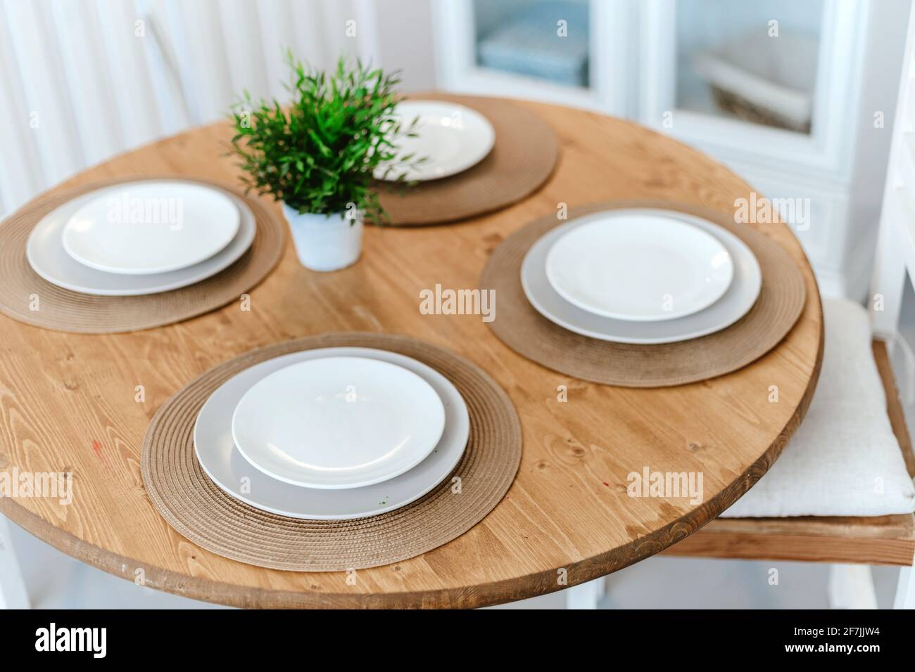 table set for dinner in a home kitchen. Stock Photo