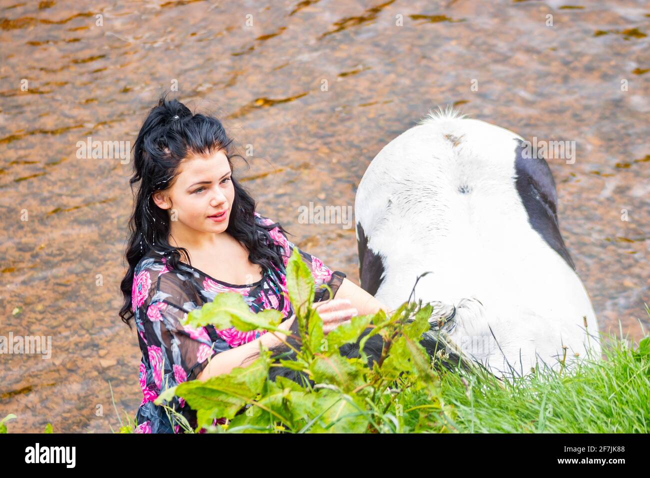 young-gypsy-traveller-woman-with-horse-in-river-at-appleby-horse-fair