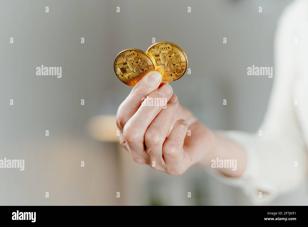 close-up. two bitcoins in the hands of a business woman. Stock Photo