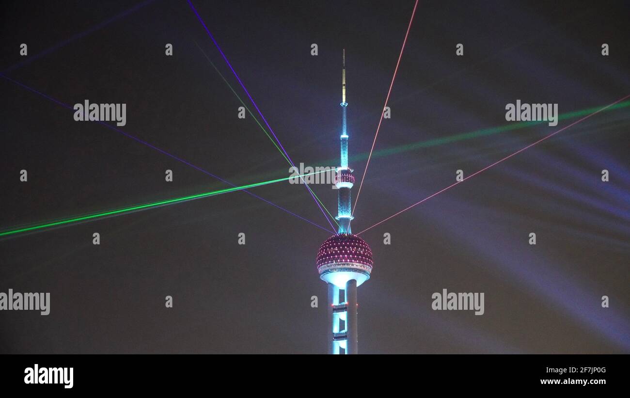 Oriental Pearl Radio & TV Tower with laser light shooting into the sky in Shanghai during night. Stock Photo