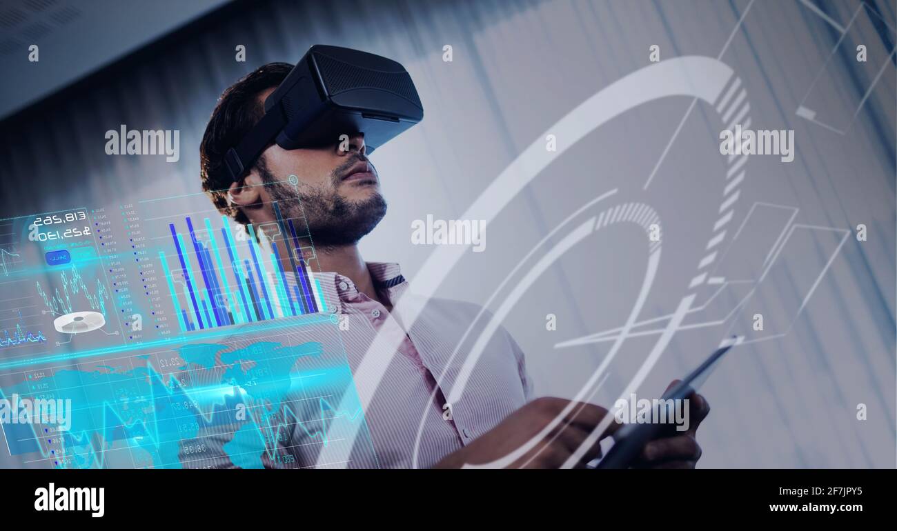 Composition of data processing over mixed race man using vr headset in background Stock Photo