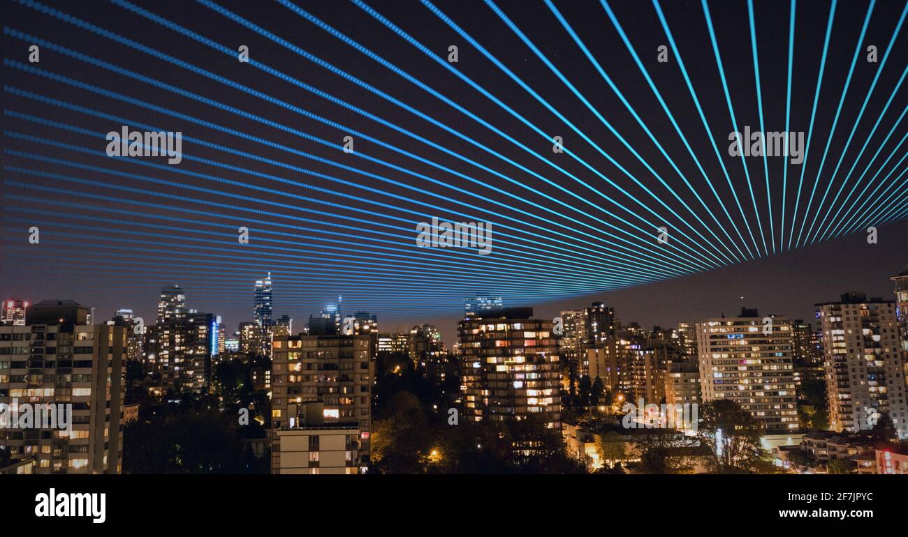 Composition of blue lines in the sky over a cityscape in background Stock Photo