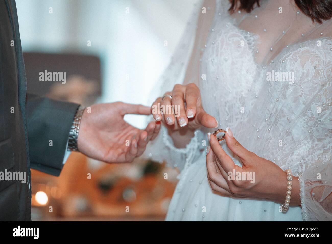 wedding ceremony, the bride and groom wear wedding rings Stock Photo Alamy