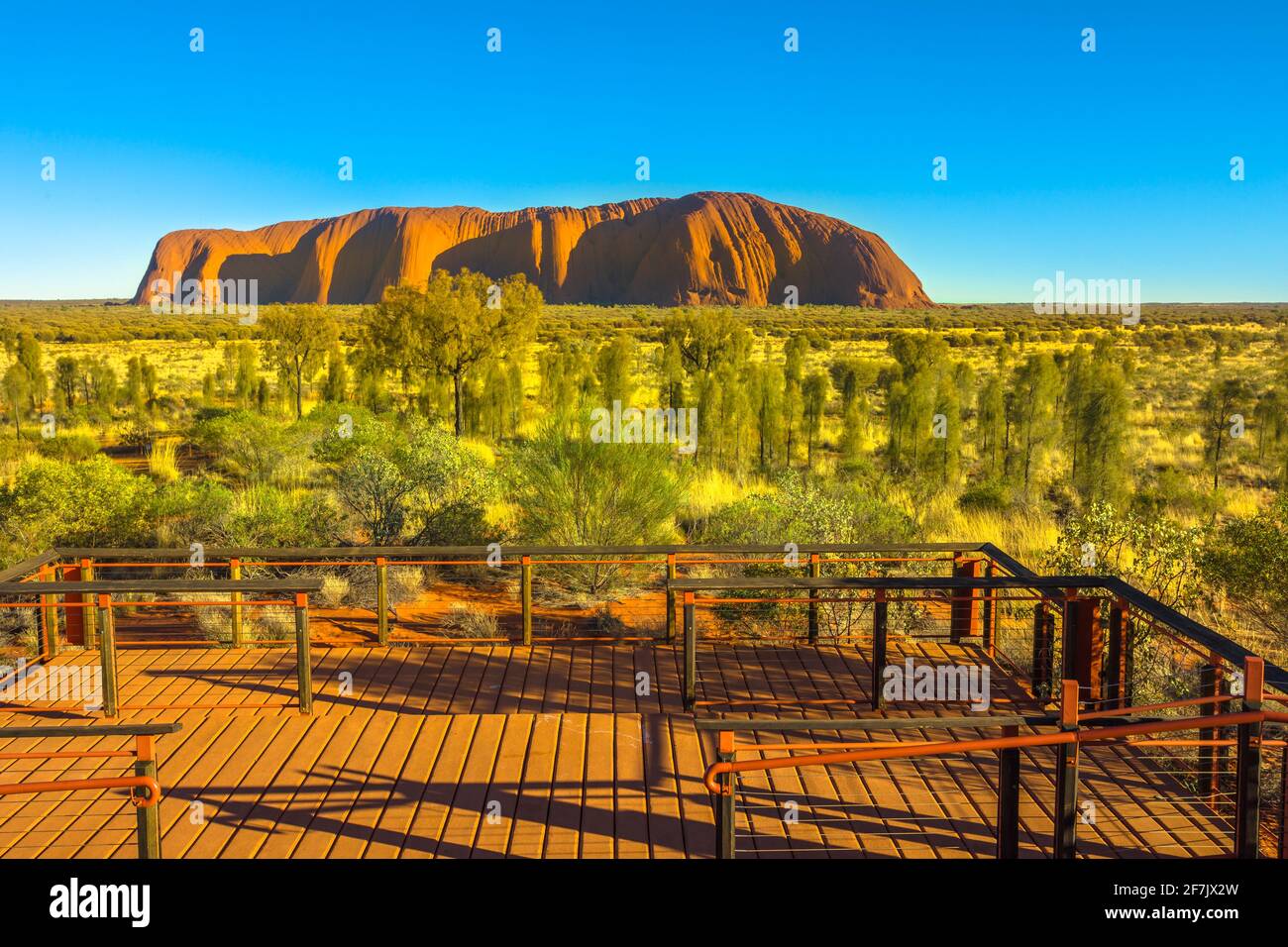 Uluru monolith, the domes of Kata Tjuta and platforms viewing area at sunlight in Uluru-Kata Tjuta National Park, Australia, Northern Territory Stock Photo