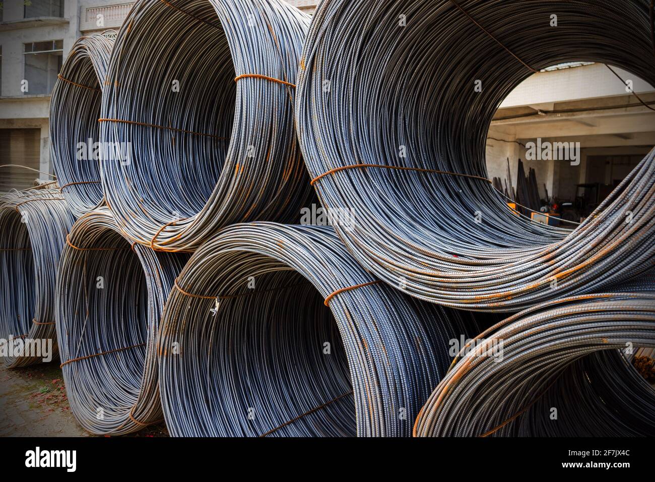 steel rebar for reinforcement concrete at construction site with house under construction background Stock Photo