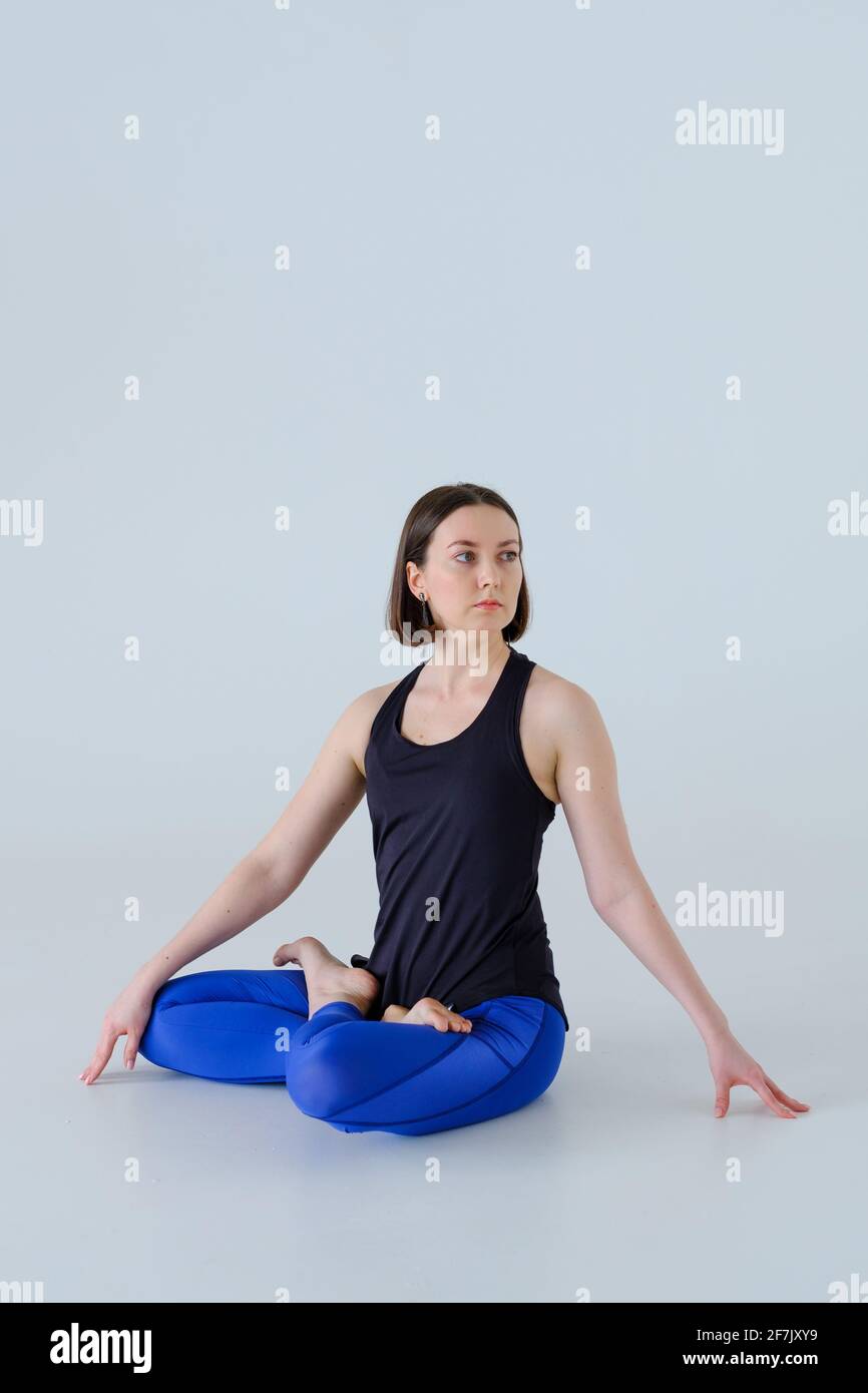 Young woman in sportswear practicing yoga. Stock Photo