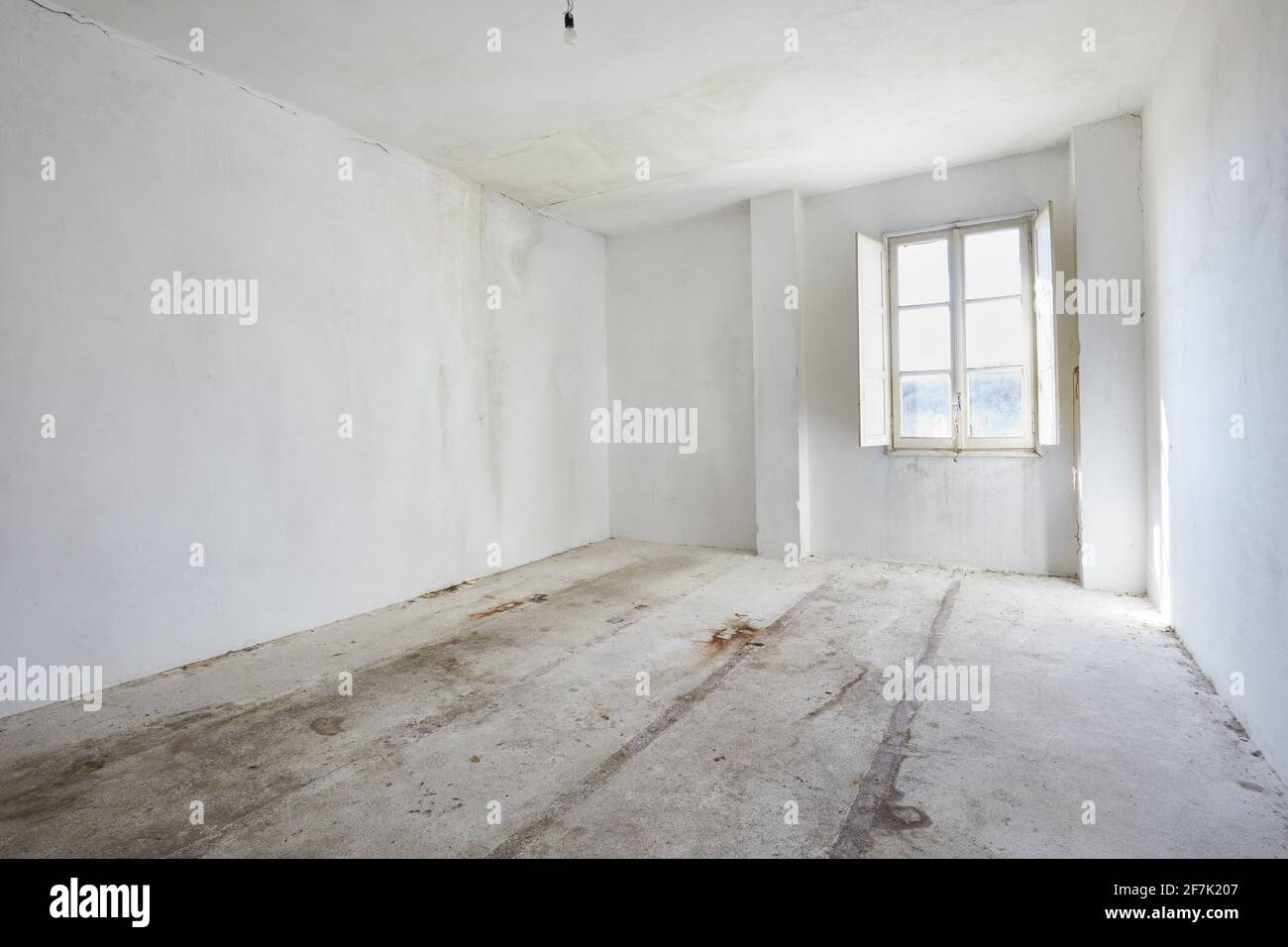 Empty, dirty room in old house, white walls Stock Photo