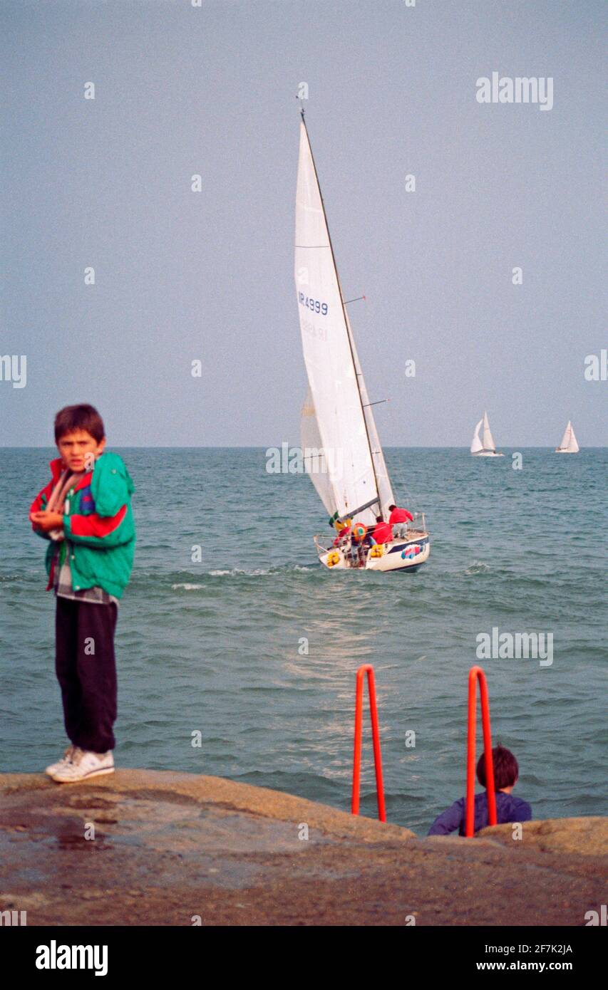 young boy and sailing boats, September 1990, Dún Laoghaire, Dublin, Ireland Stock Photo