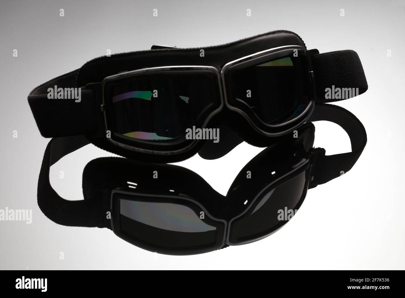 Close-up of black leather motorcycle rider's glasses with reflection on mirror surface. Eye protection wear. Stock Photo