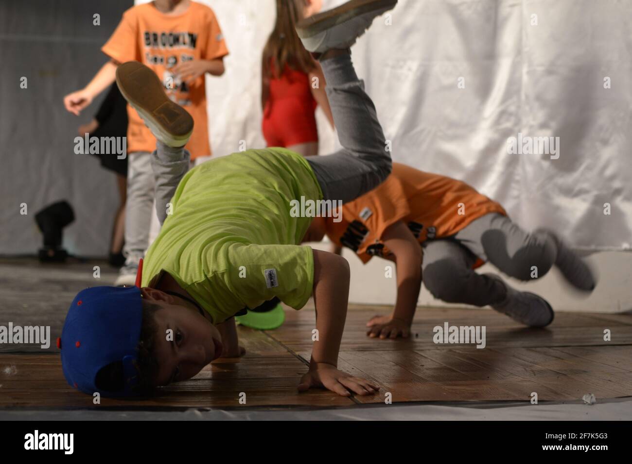 Boys dancing breakdance in frozen baby position. Baby freeze breakdance. Stock Photo