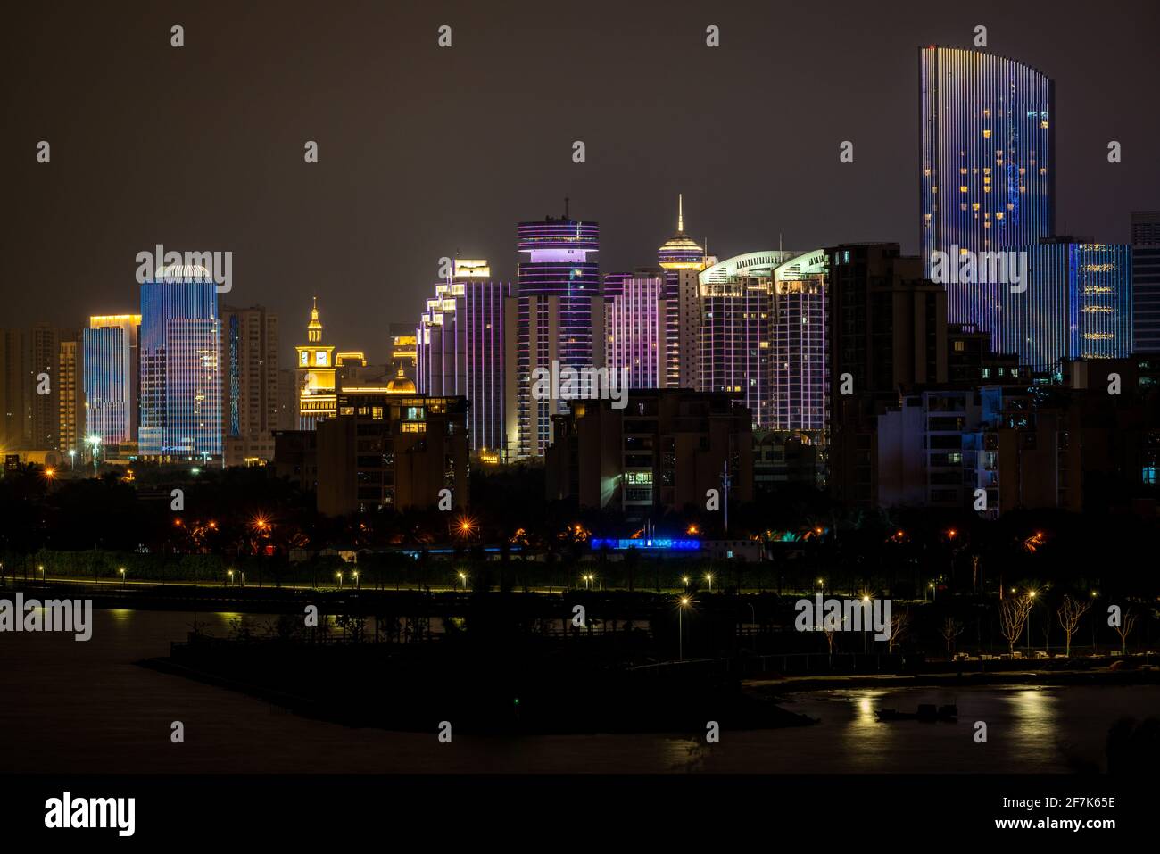 Haikou modern buildings cityscape illuminated at night in Haikou Hainan China Stock Photo