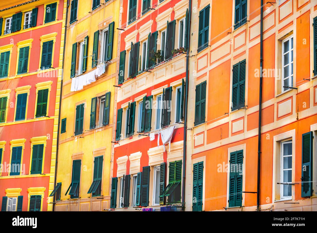 Italian style windows orange yellow buildings intense colorful background texture Stock Photo