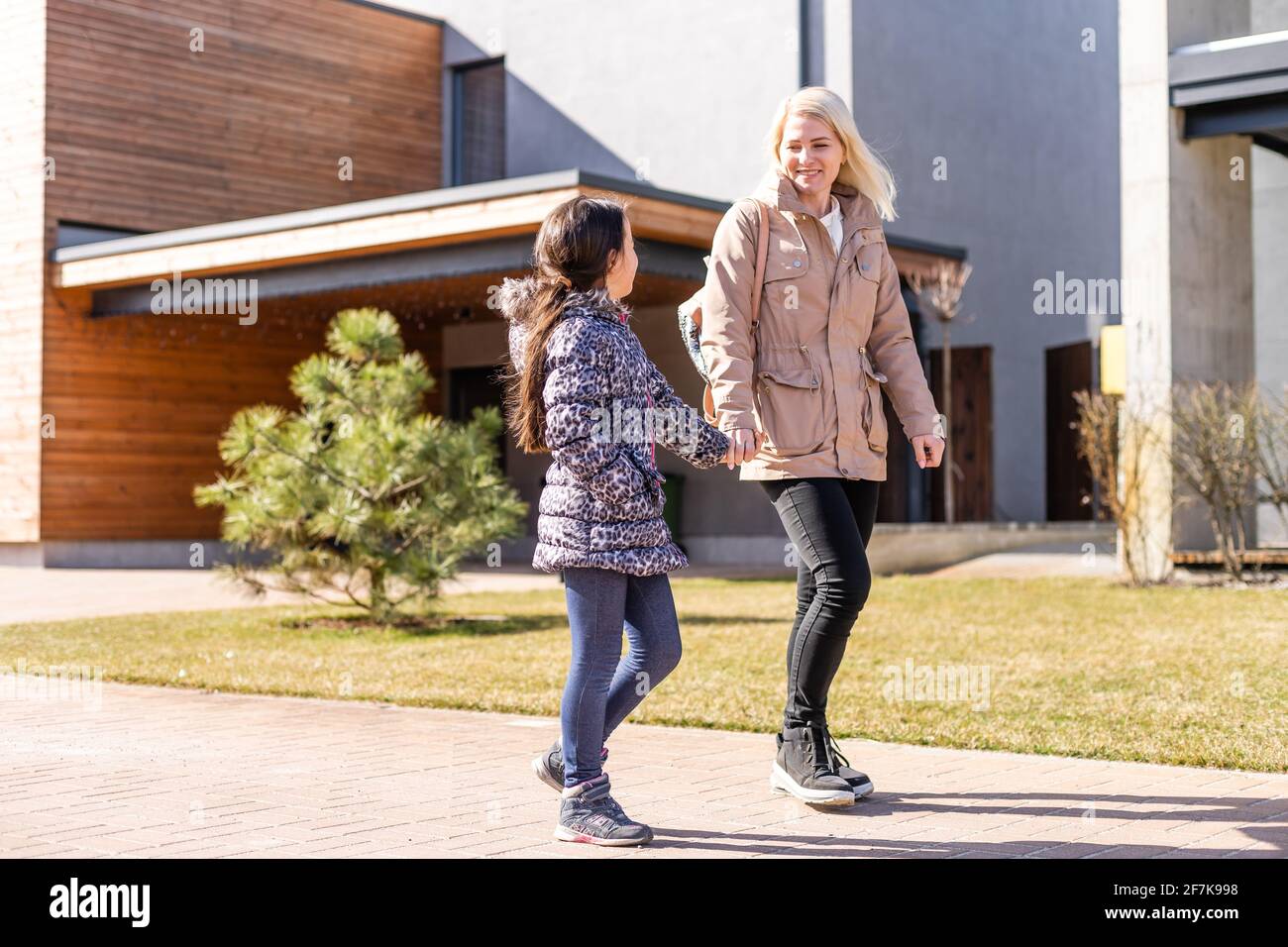 Happy family standing near their new house Stock Photo - Alamy