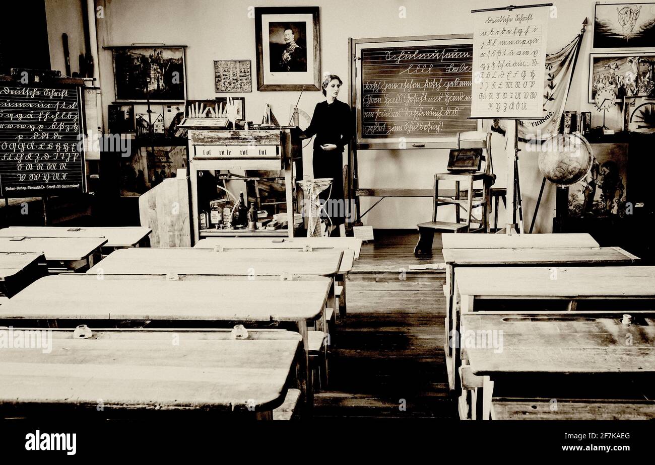 old historical classroom with woman teacher, altes historisches Klassenzimmer mit Lehrerin Stock Photo