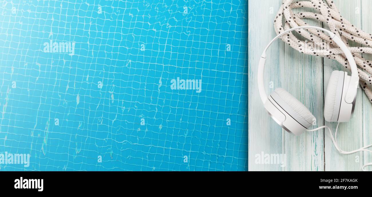 Boat rope, headphones and water surface of swimming pool. Travel and vacation concept. Top view flat lay with copy space Stock Photo