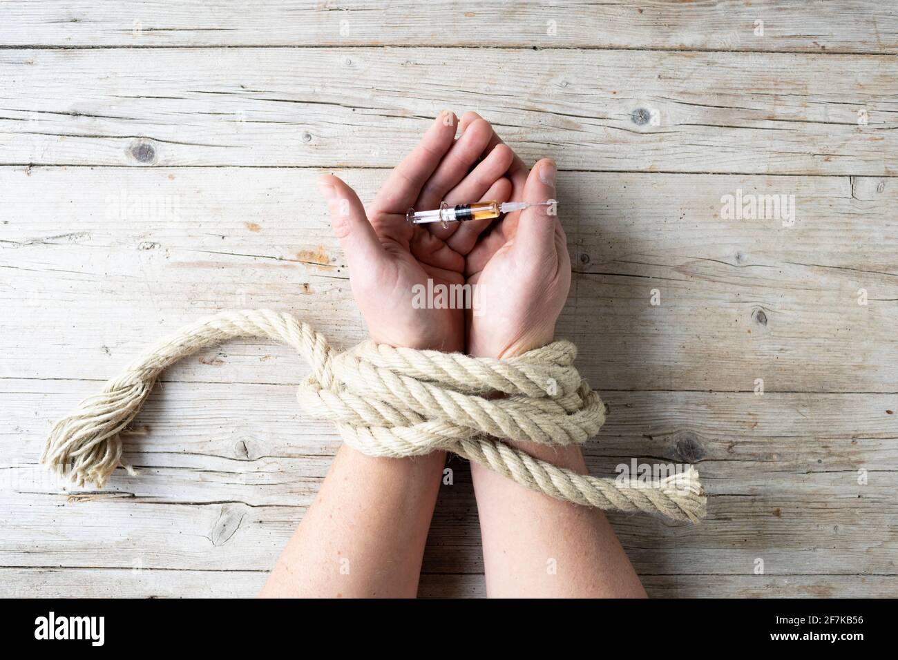 male hands are tied and hold syringe, concept addiction, drugs, drug addiction, photo taken from above Stock Photo