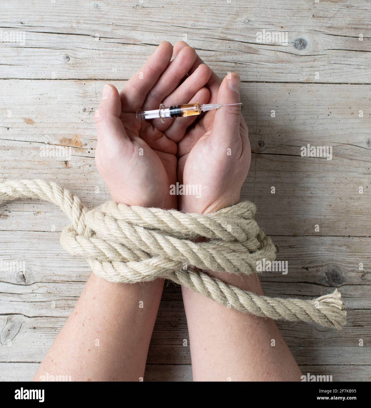 male hands are tied and hold syringe, concept addiction, drugs, drug addiction, photo taken from above Stock Photo