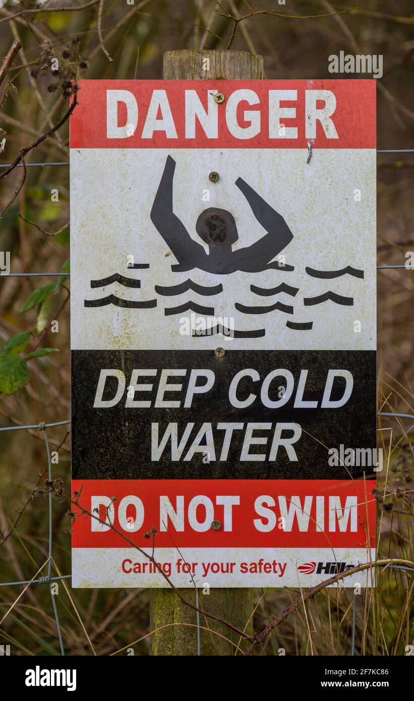 Sign warning of danger of deep cold water Hills waste management, Calne, Wiltshire, England, UK Stock Photo