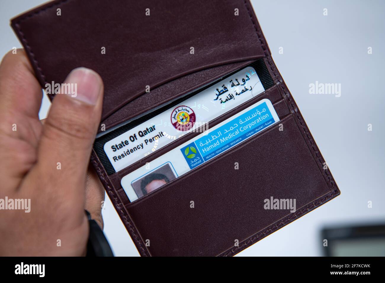Qatari ID Card and Health Hard in Leather Valet on Isolated Background