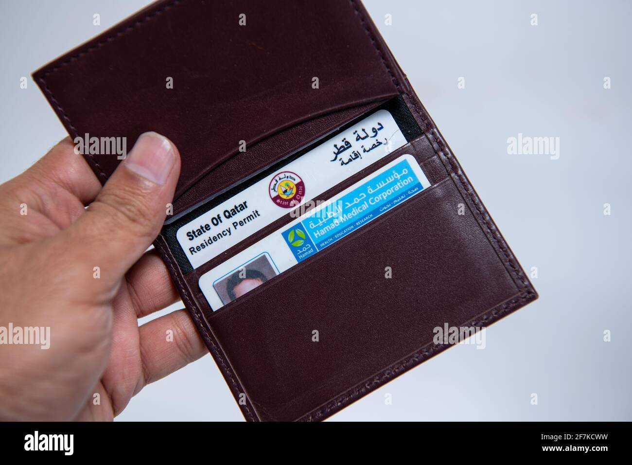 Qatari ID Card and Health Hard in Leather Valet on Isolated Background Stock Photo