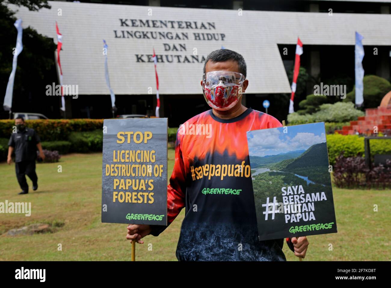 Jakarta, Indonesia. 08th Apr, 2021. An environmental activist holds placards expressing his opinion during the demonstration.Greenpeace staged an action in front of the Ministry of Environment's building to stop violations of issuing forest release permits in Papua. The purpose of this action is to demand that the Government take corrective actions that forests and plantations that have not been damaged can be returned to the Indigenous Papuan people. (Photo by Aslam Iqbal/SOPA Images/Sipa USA) Credit: Sipa USA/Alamy Live News Stock Photo